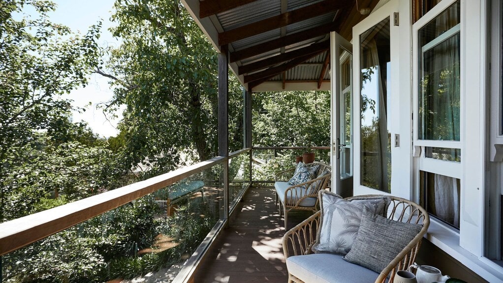 Milk and Honey in Daylesford with Wombat Hill views, a wraparound verandah and eclectic antique-filled interiors.