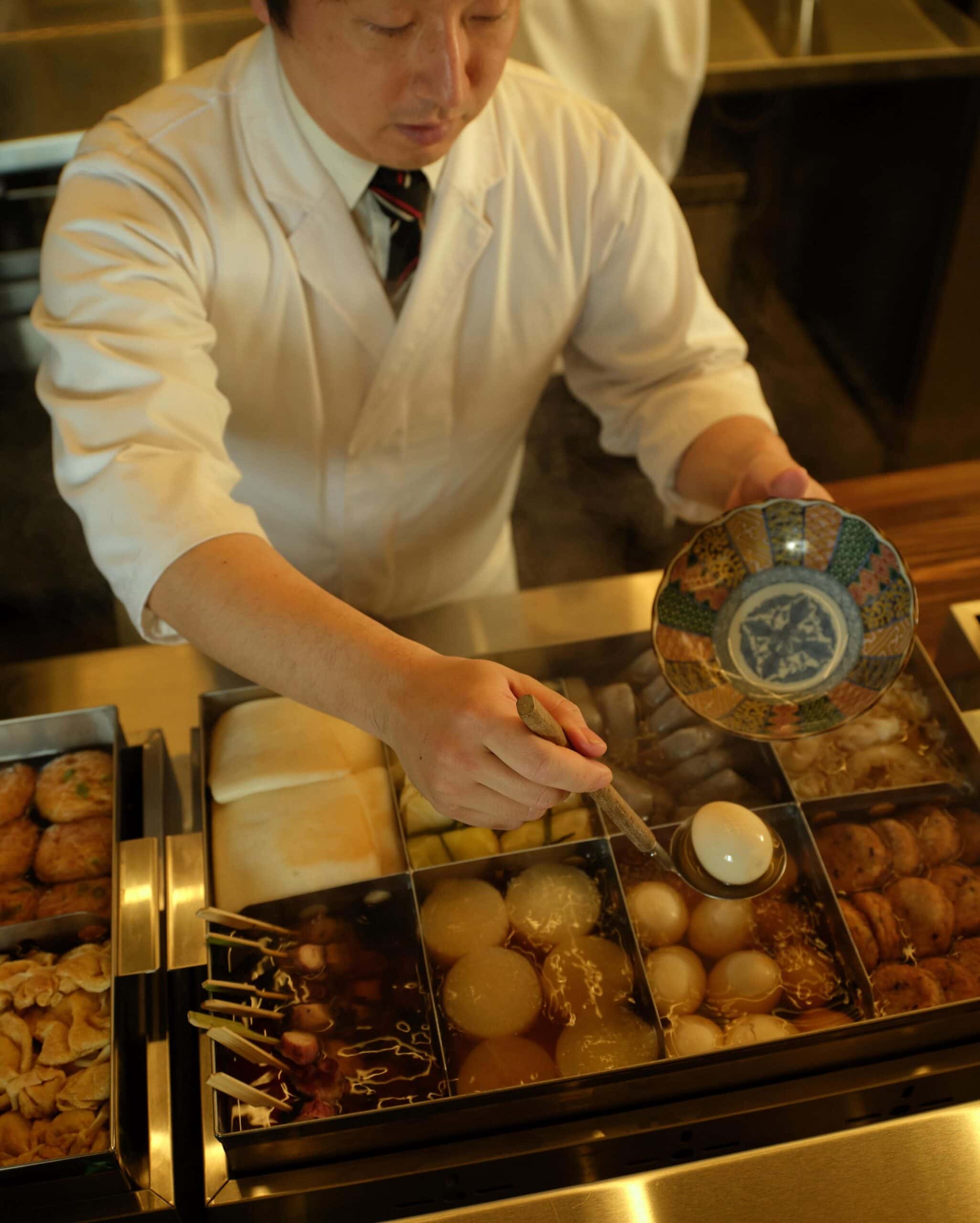 chef serving up a bowl at oden melbourne