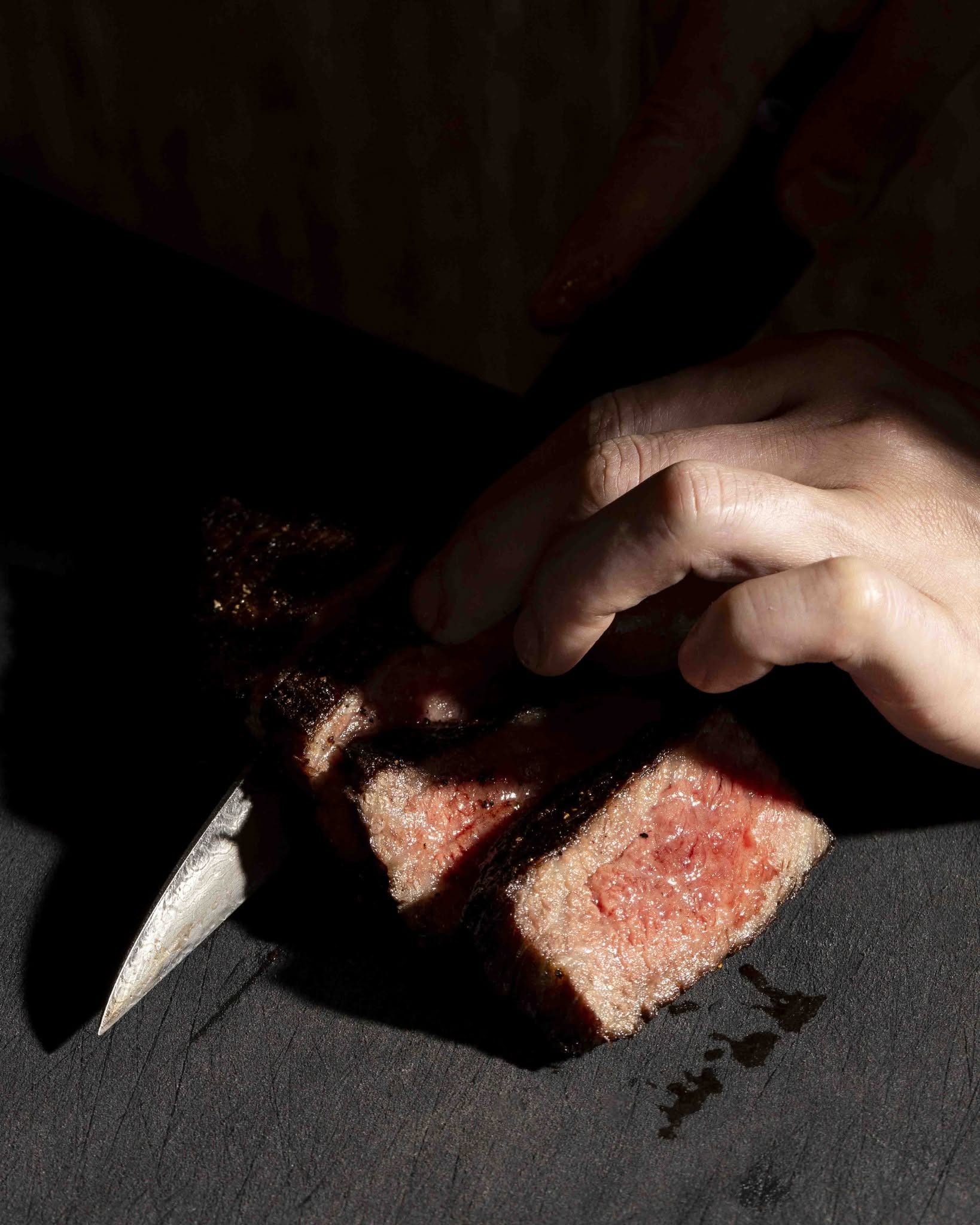steak being sliced at yakikami melbourne japanese restaurant