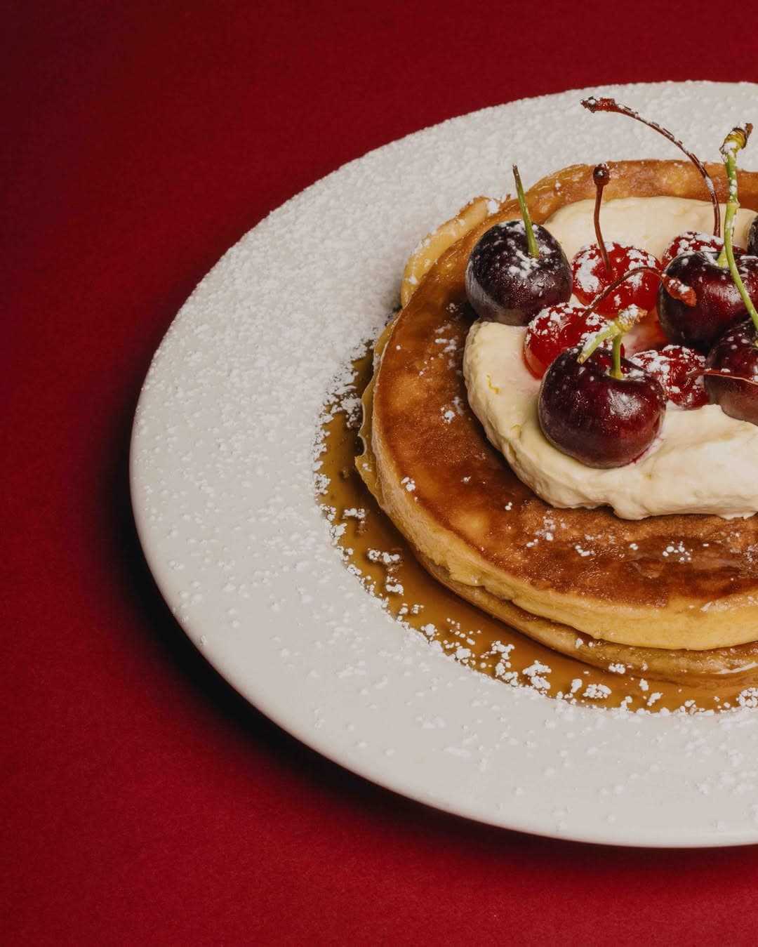 vanilla pancake stack topped with maple and miso mascarpone and fresh cherries