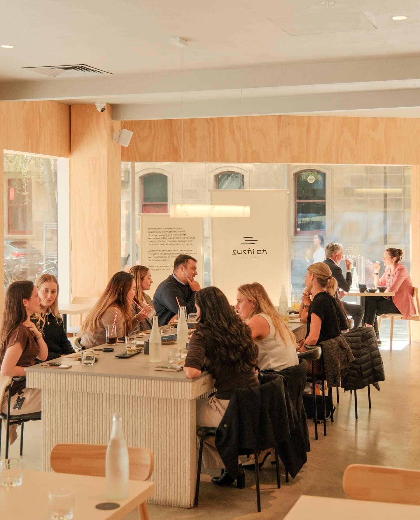 diners in the light-filled room of sushi on little bourke melbourne