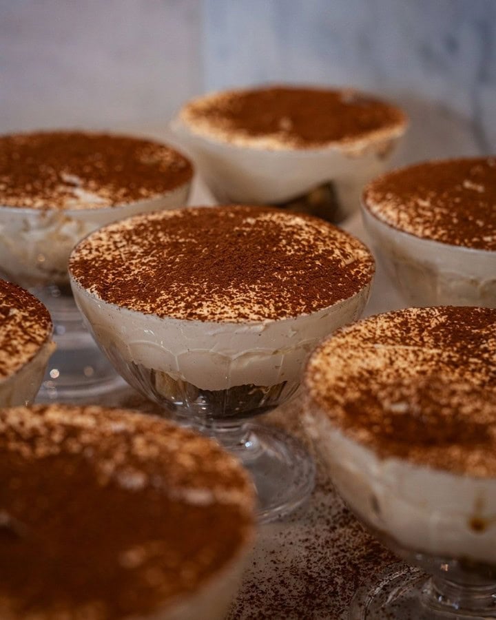 Freshly made tiramisu with mascarpone cream espresso-soaked biscuits and cocoa dusting served in glass coupes at Rivareno Gelato Sydney