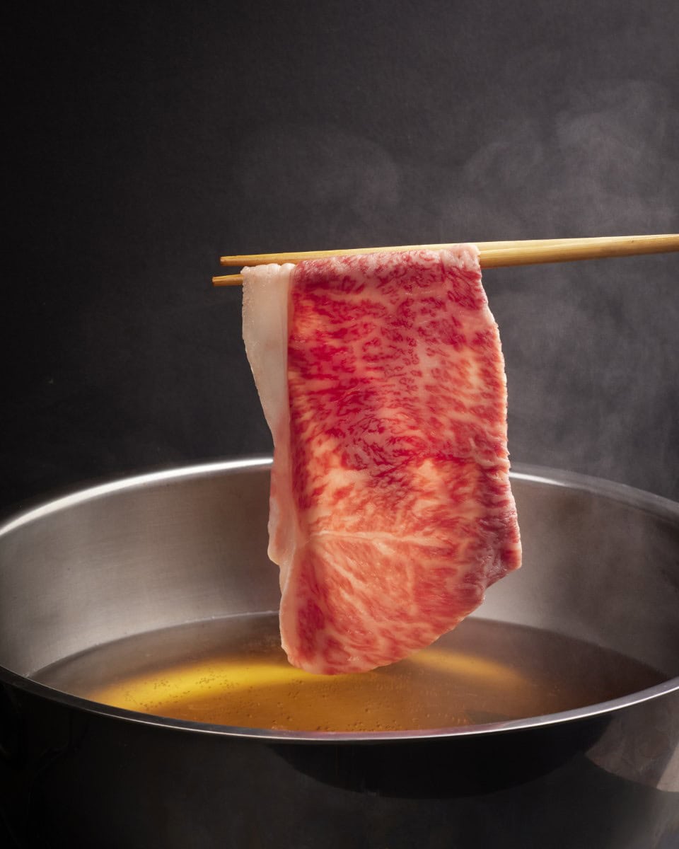 A5 wagyu beef dipped into hot pot broth at Hanasuki Chatswood Sydney