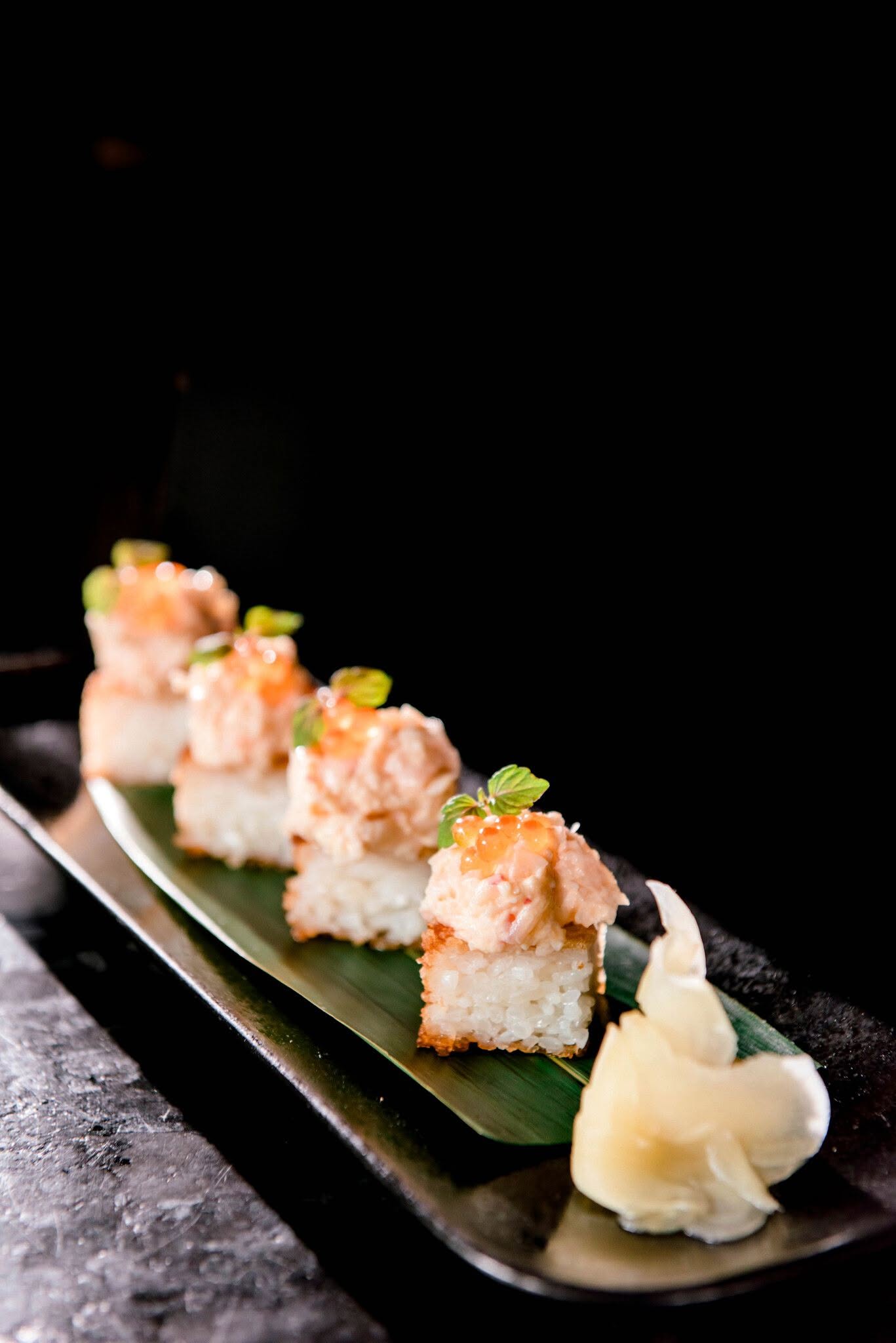 a row of immaculately prepared sushi at yamagen