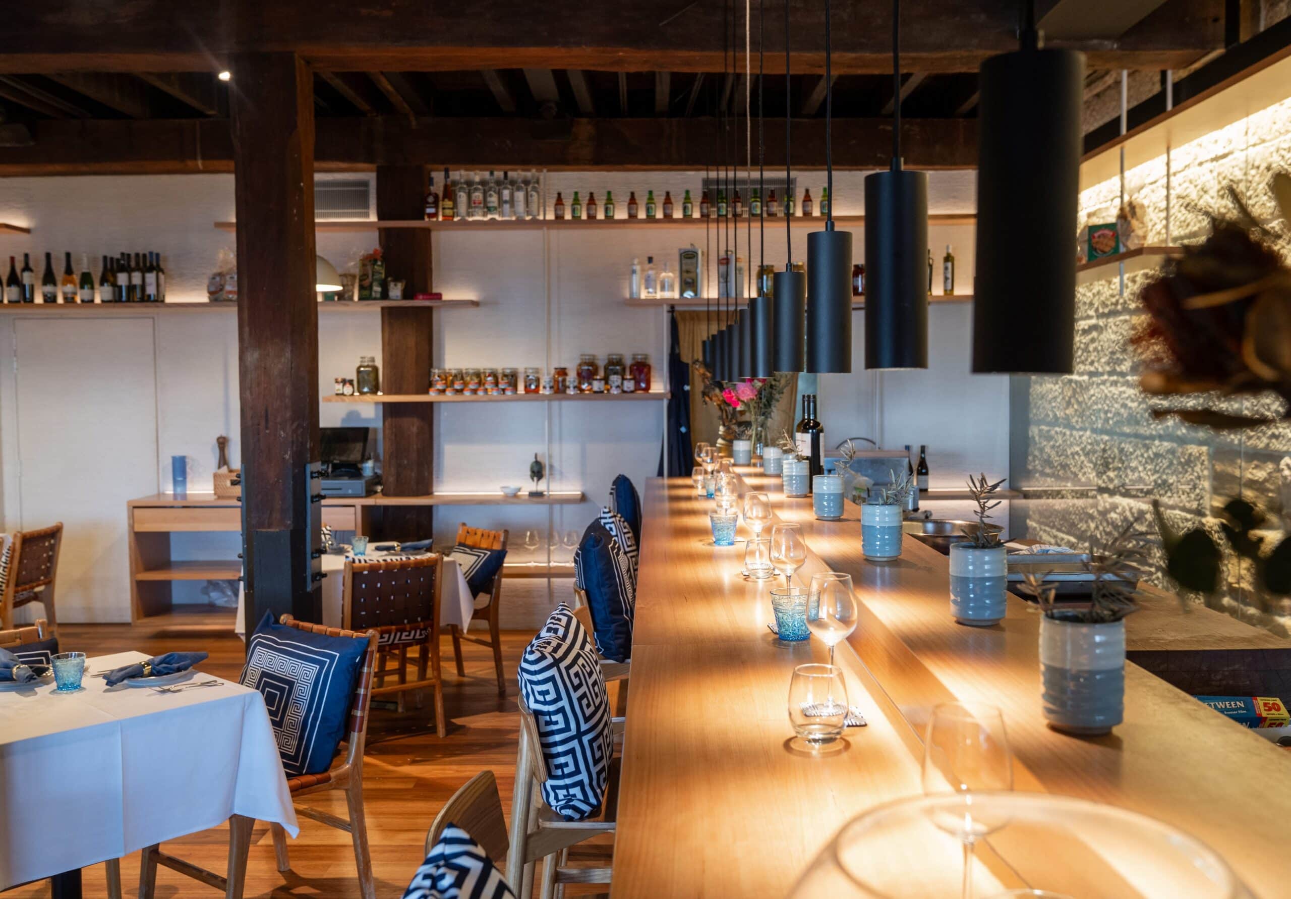 interior shot of jimmys kitchen including bar seating, standard seating and sandstone walls