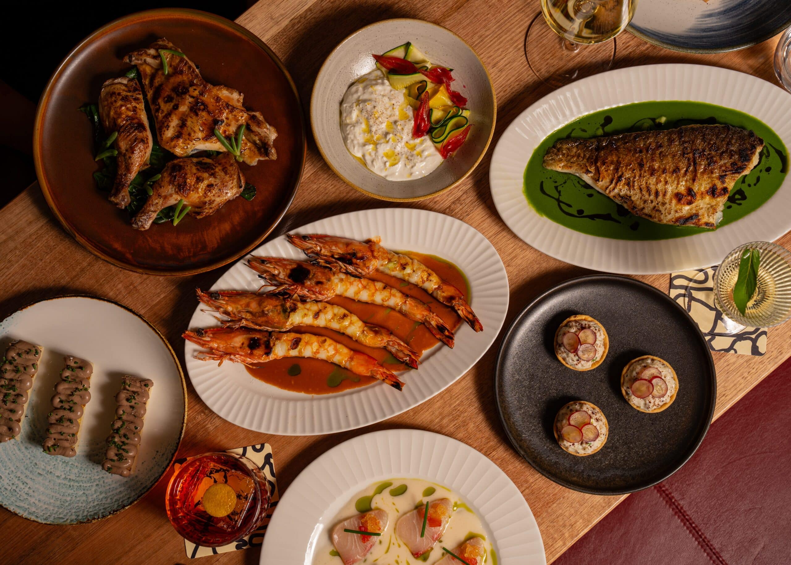 Overhead spread of grilled chicken, king prawns, market fish and tartlets at Elliott's Balmain Sydney