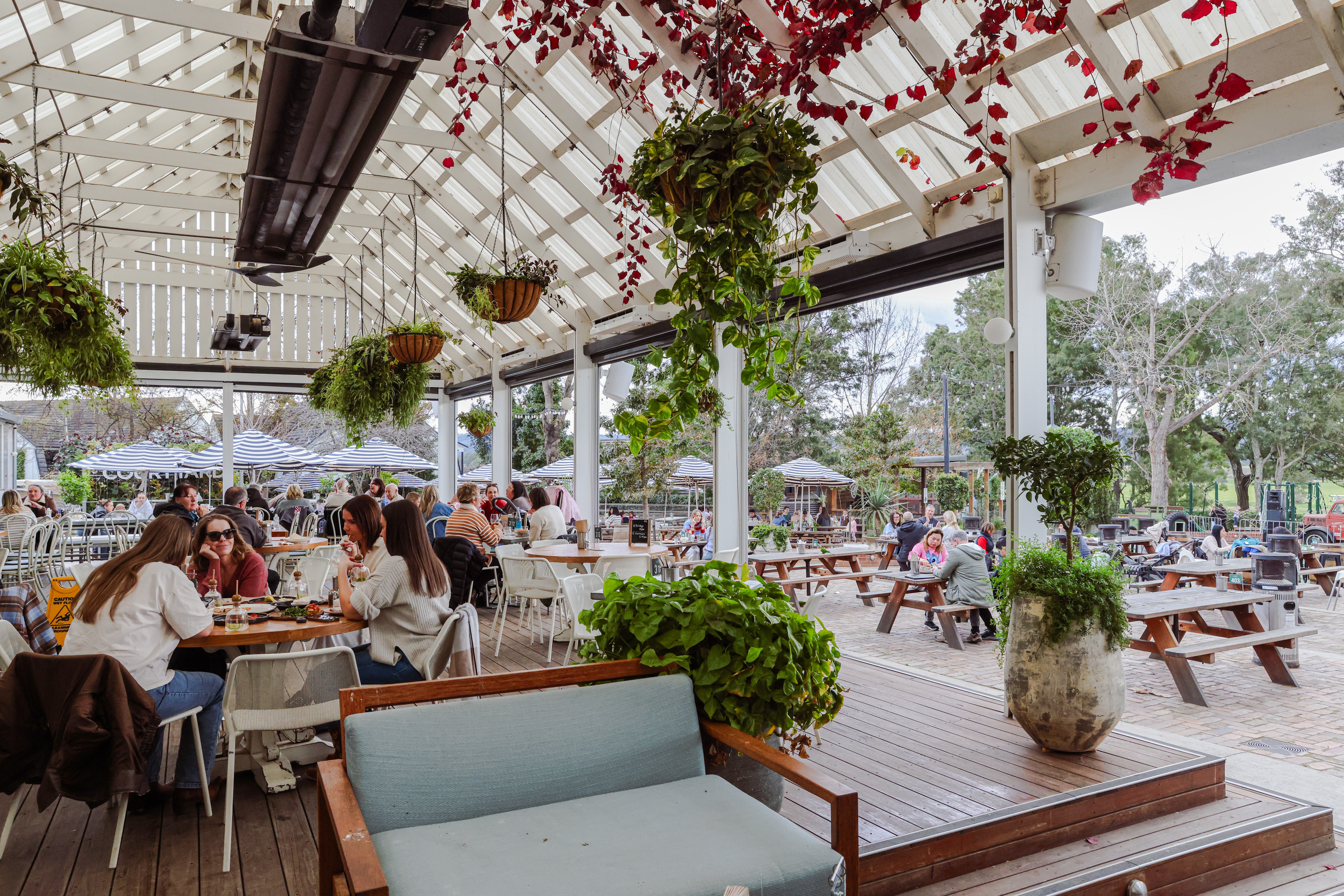 Outdoor beer garden with string lights and heritage buildings at Camden Valley Inn, Cawdor