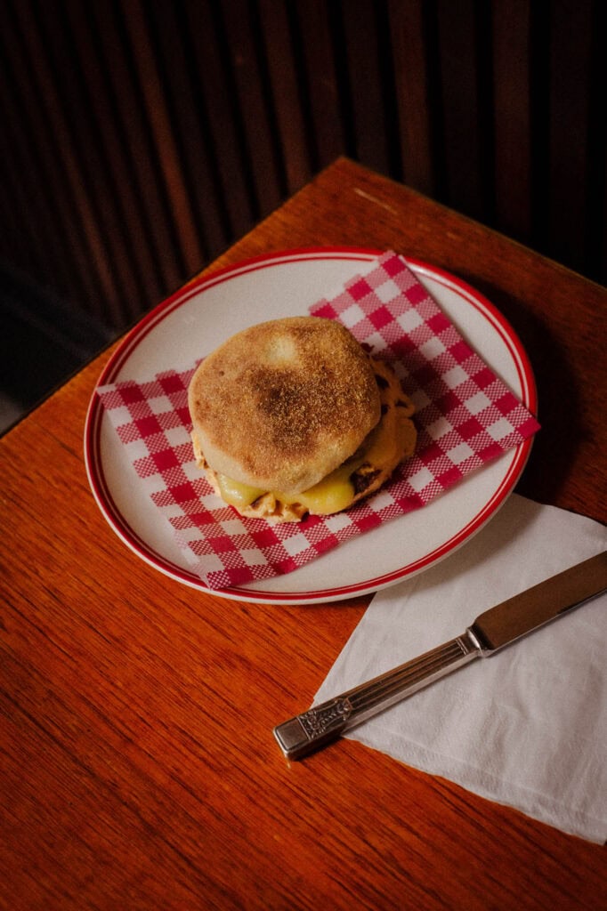 English muffin breakfast sandwich with melted cheese at Ken's Continental Rushcutters Bay Sydney
