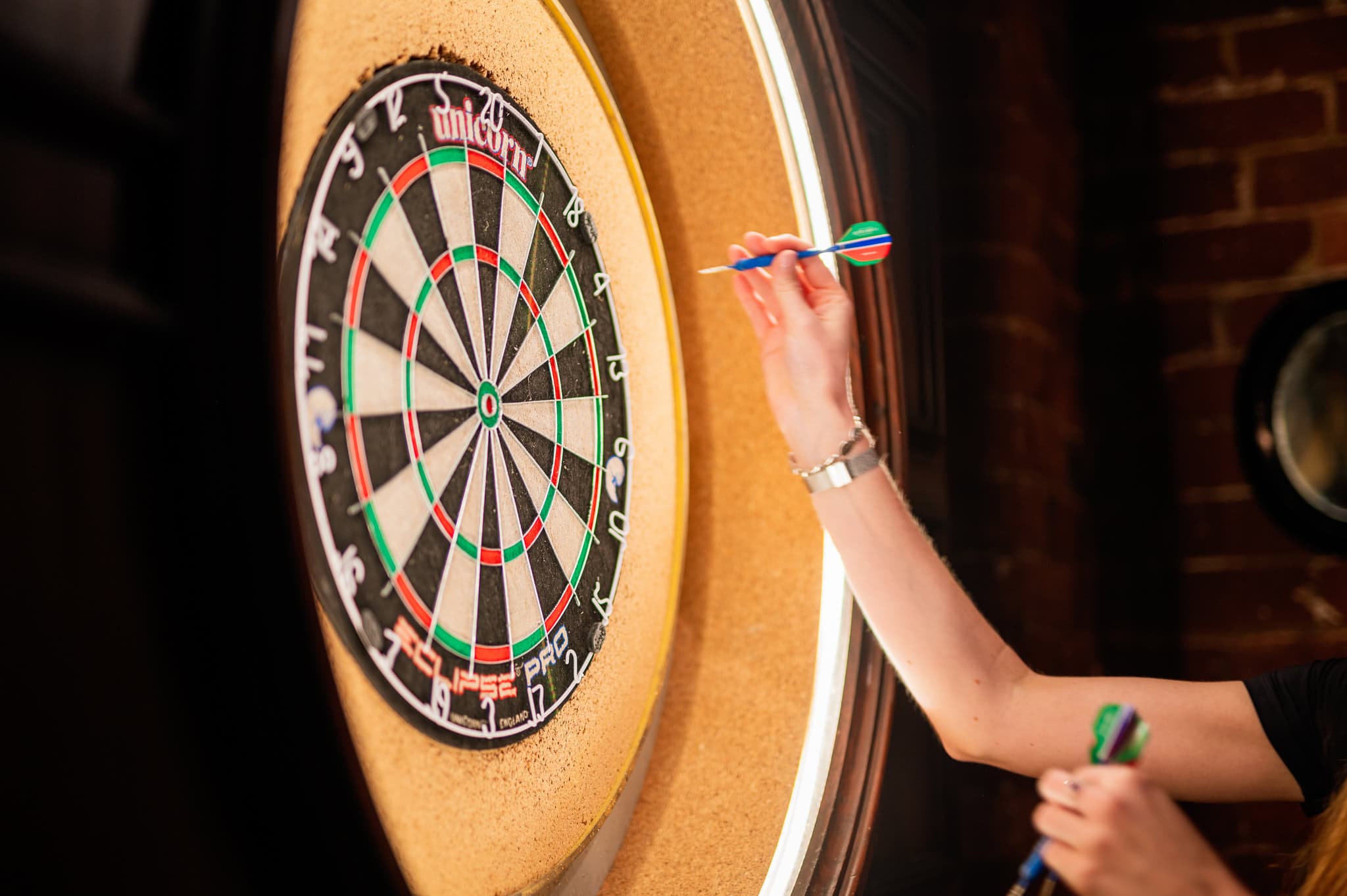 Close up of hand throwing dart at dartboard inside Flight Club The Rocks Sydney