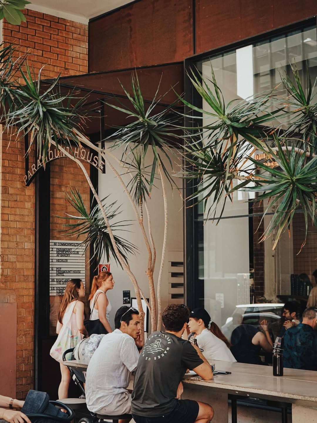 The exterior of Paramount Coffee Project in Surry Hills with people enjoying their coffee on seating out the front.