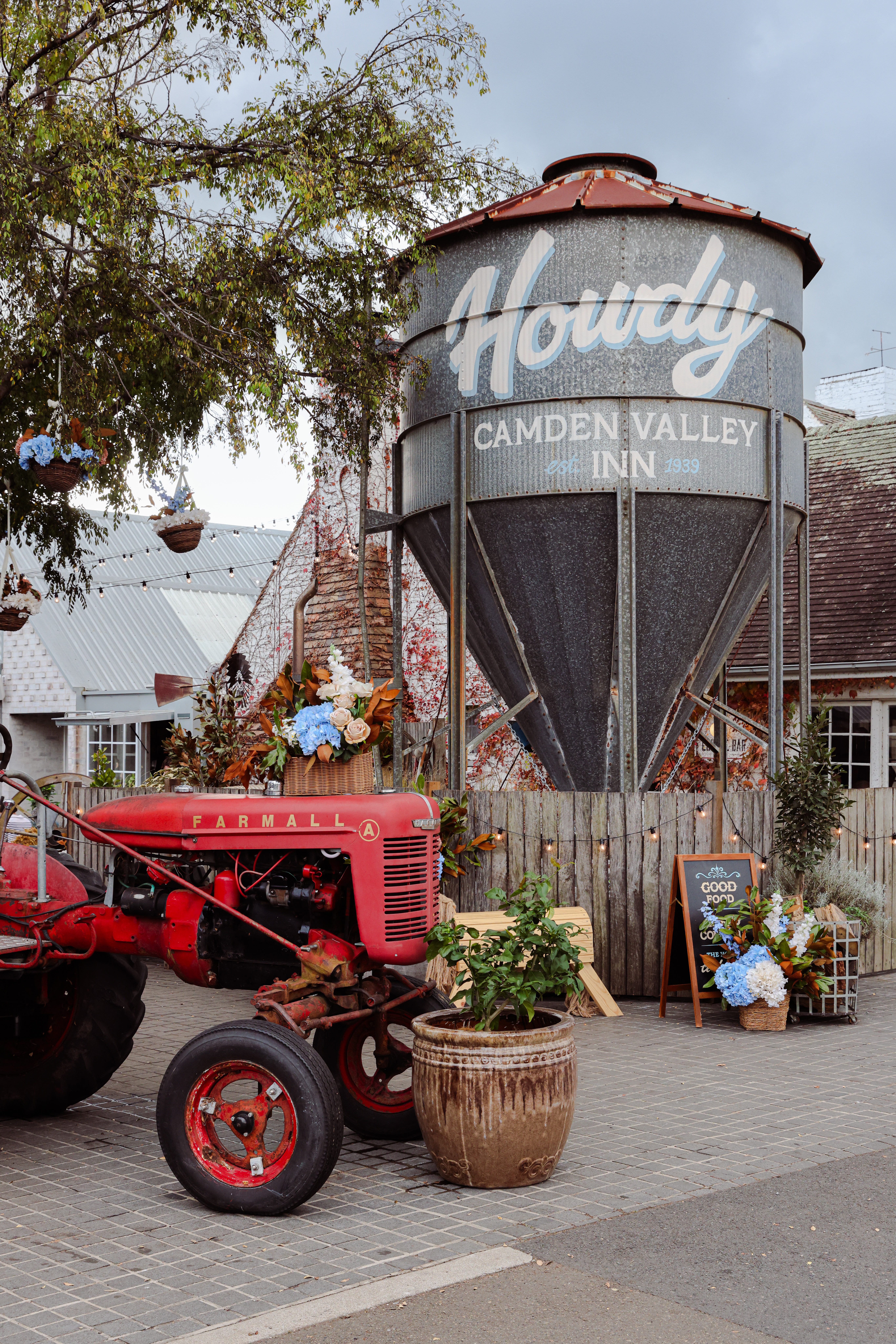 Vintage tractor beside the Howdy Camden Valley Inn silo signage, Cawdor