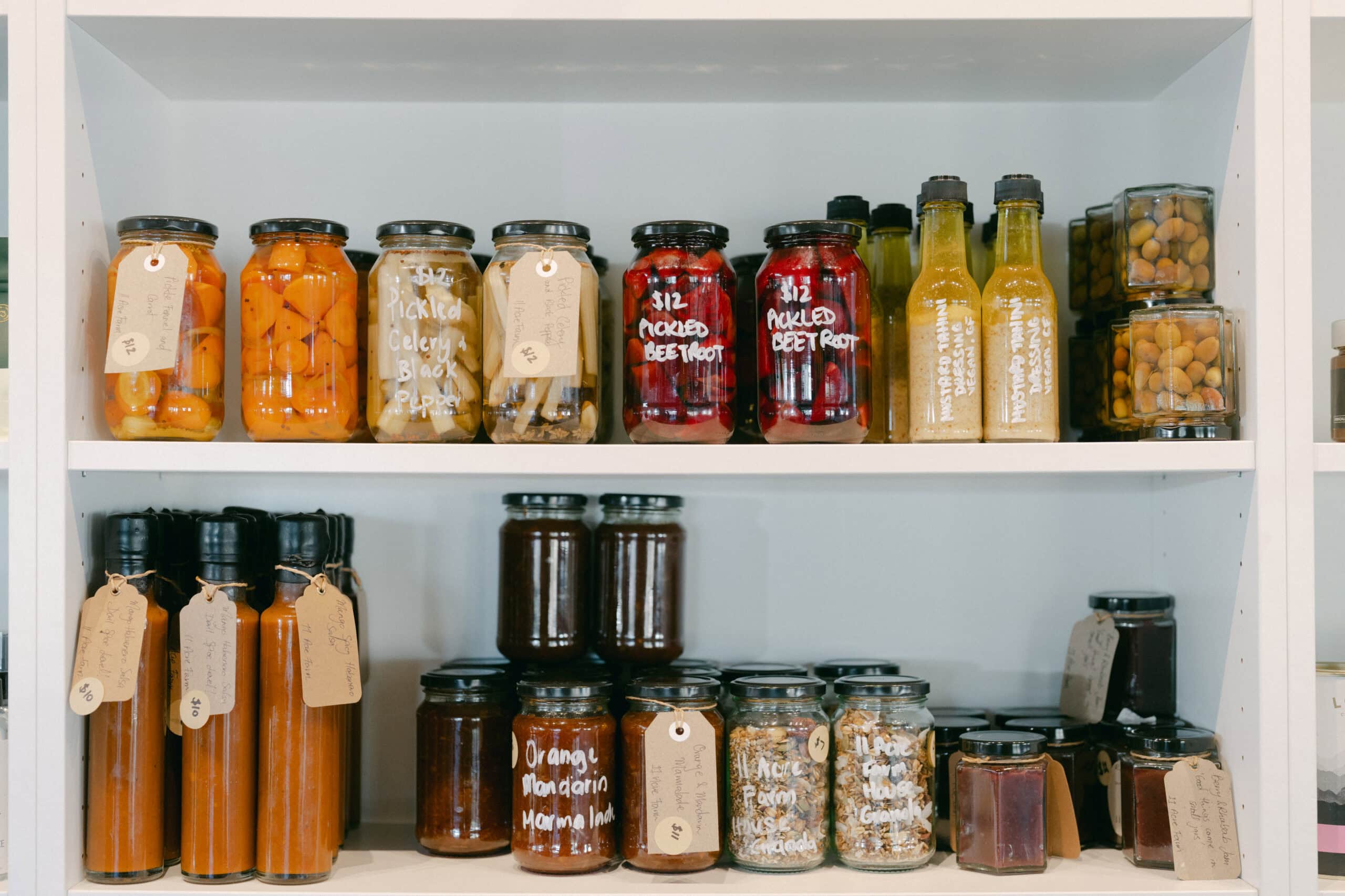 Cabinets full of house-made pickles and condiments at 11 Acre Farm