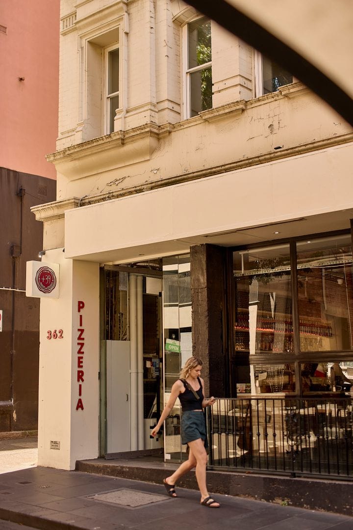 Street shot with woman walking past +39 Pizzeria in Melbourne CBD