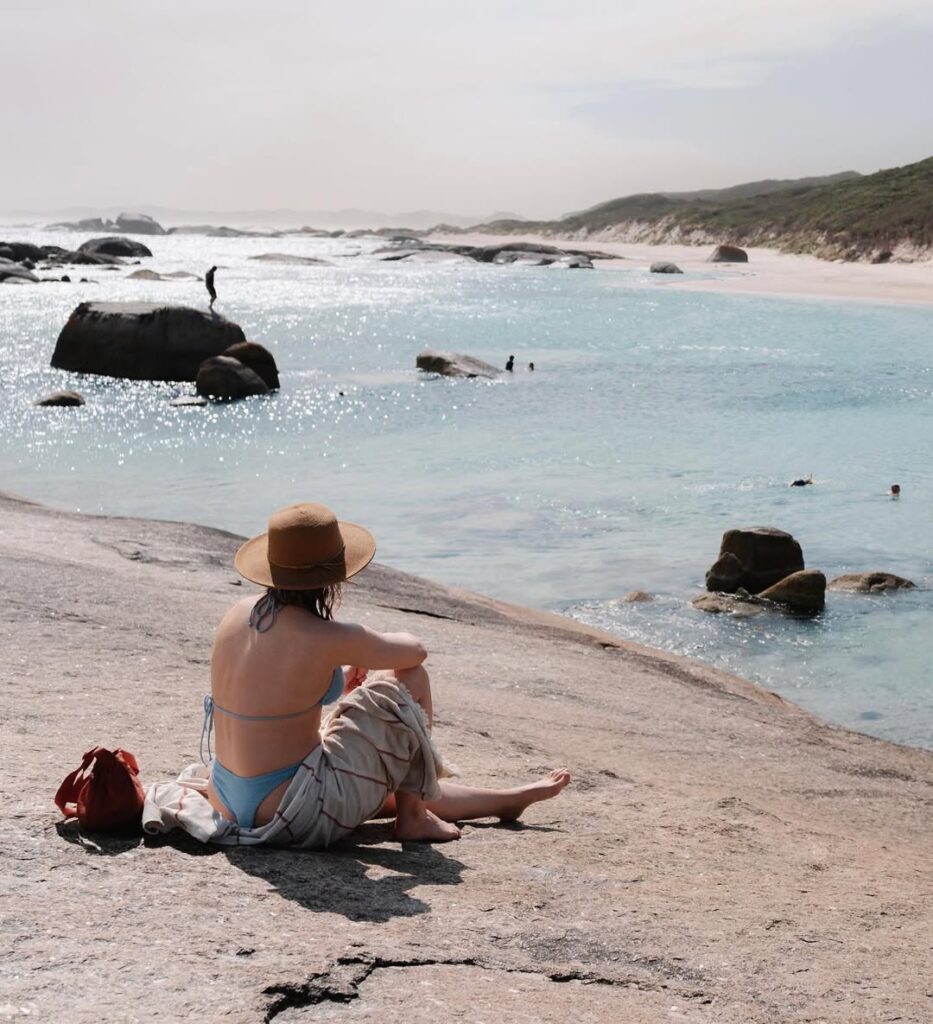 Someone sitting on the rocks at Greens Pool in Denmark