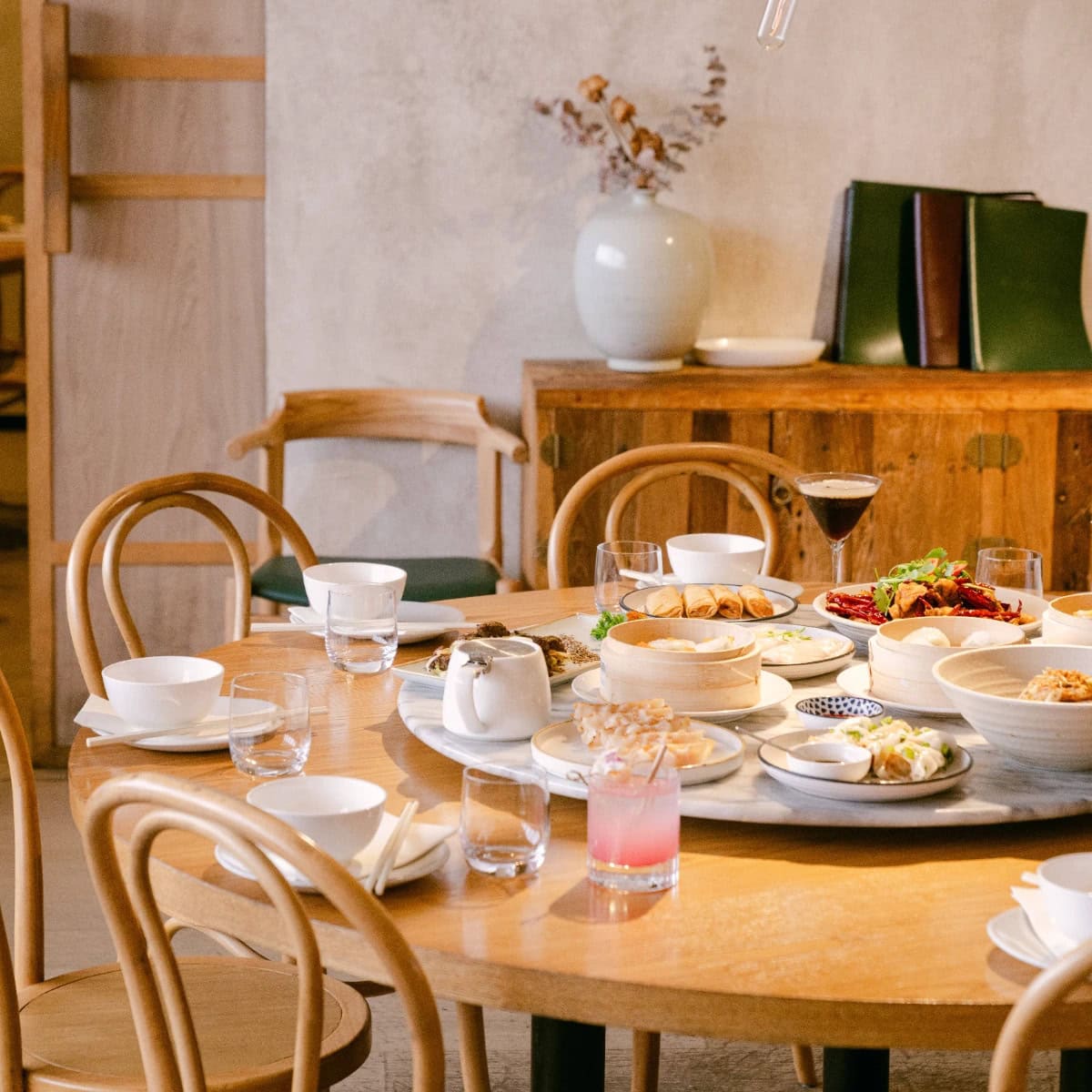 A large round table with a Lazy Susan set with a yum cha feast at Mama Mulan in Chatswood.