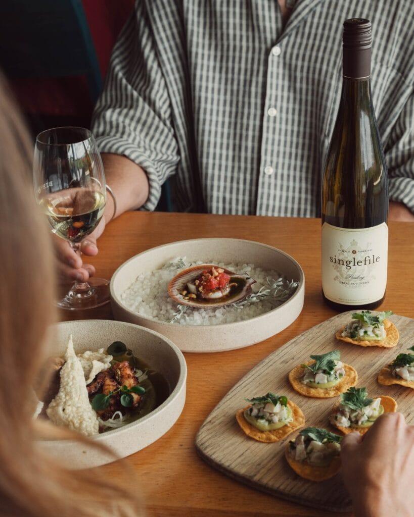 A table filled with eats and drinks from Singlefile Wines