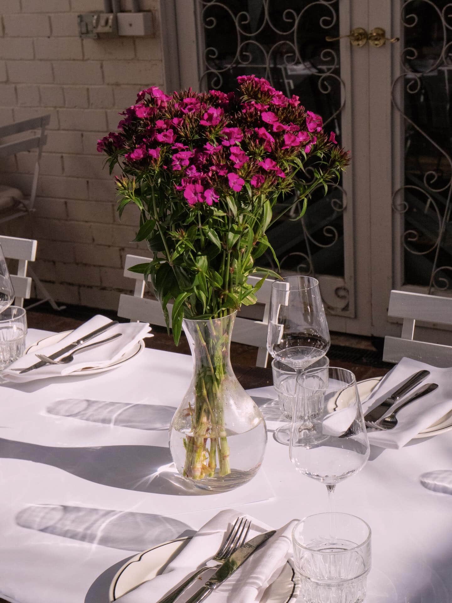 a table setting with flowers at 98 Lygon Street Melbourne, a Sitchu award winner, best date night spot melbourne.