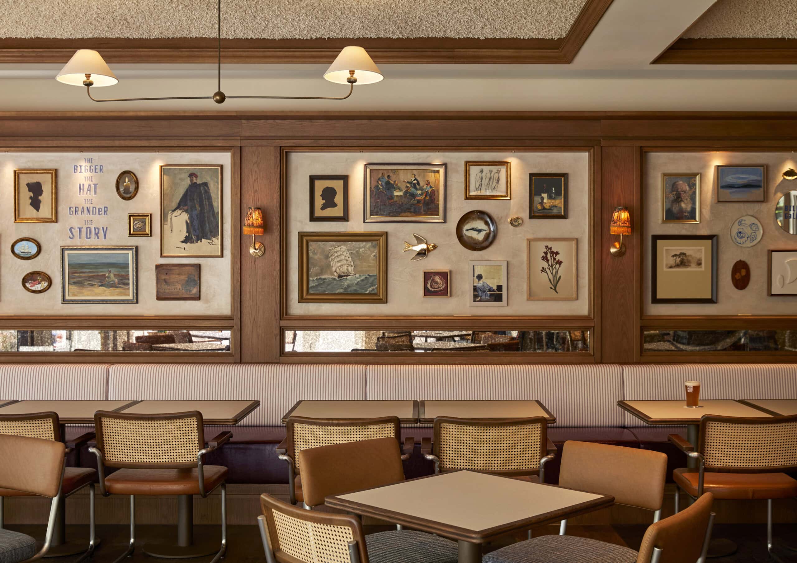 Bar dining room with striped banquette seating cane chairs and eclectic gallery wall Old Commodore Hotel McMahons Point Sydney