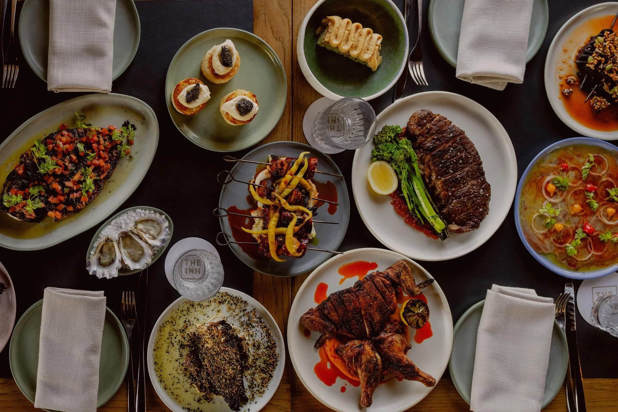 Edgar's Inn shared feast spread with grilled steak oysters caviar blinis roast chicken and broth dishes Ainslie Canberra