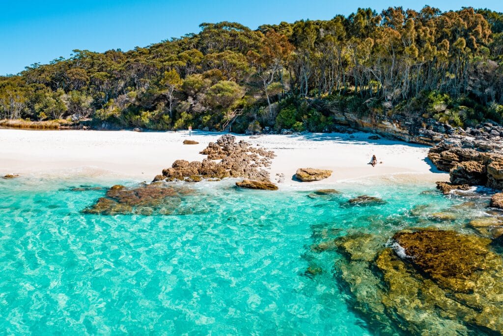Jervis Bay white sand beach with turquoise clear water rocky outcrops and bushland Shoalhaven NSW