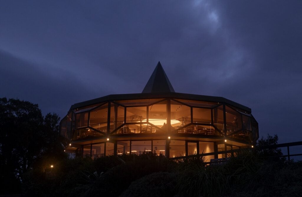 Lunetta restaurant circular glass exterior glowing at night atop Red Hill Lookout Canberra