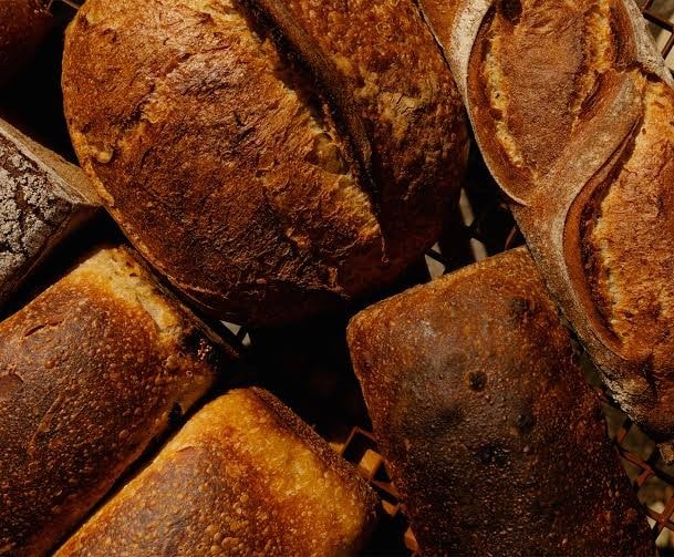 Under Bakery freshly baked long-ferment sourdough loaves in a basket Mawson Canberra