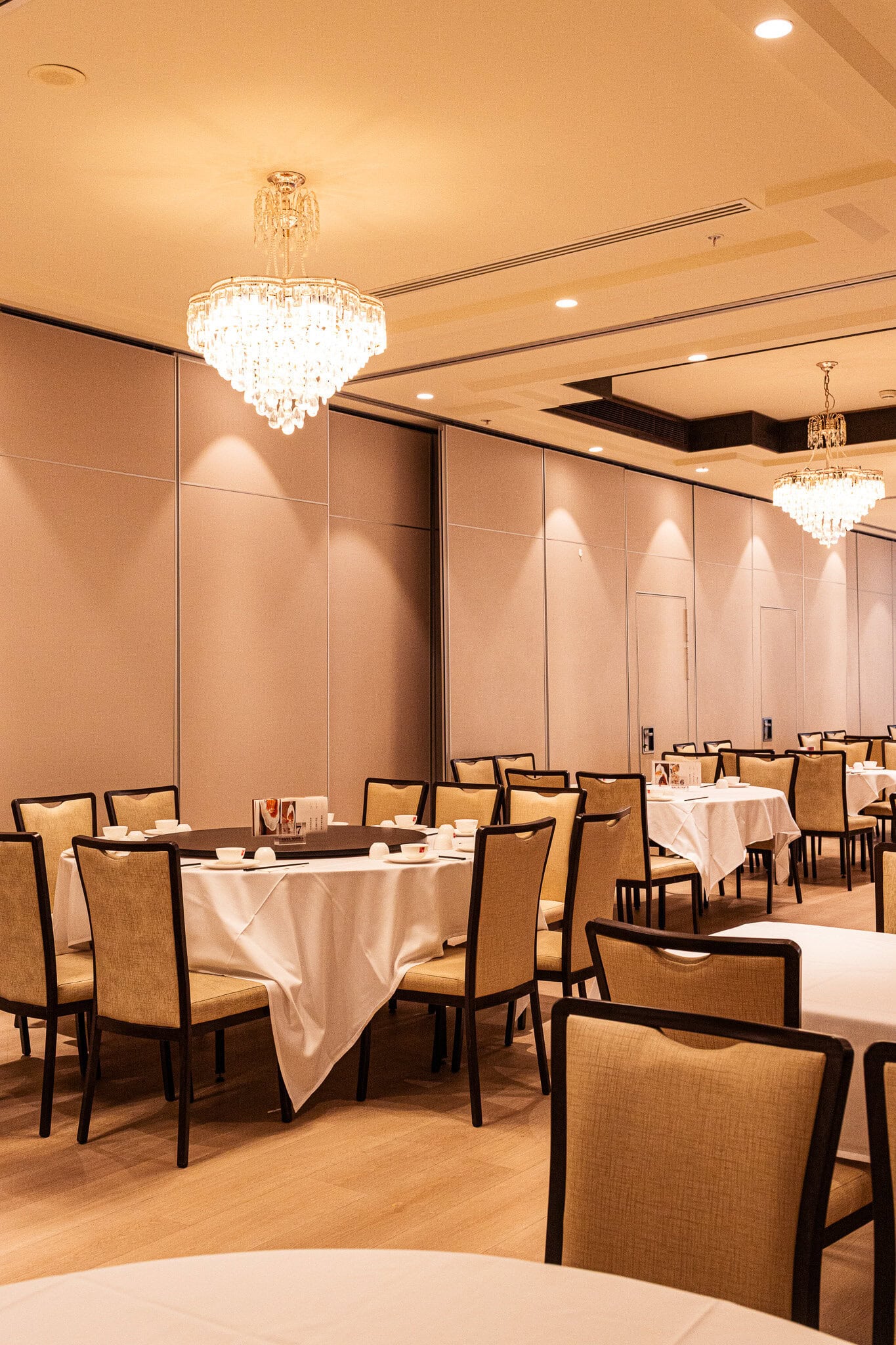 interior shot of diamond territory yum cha sydney cbd with circular tables and chandeliers