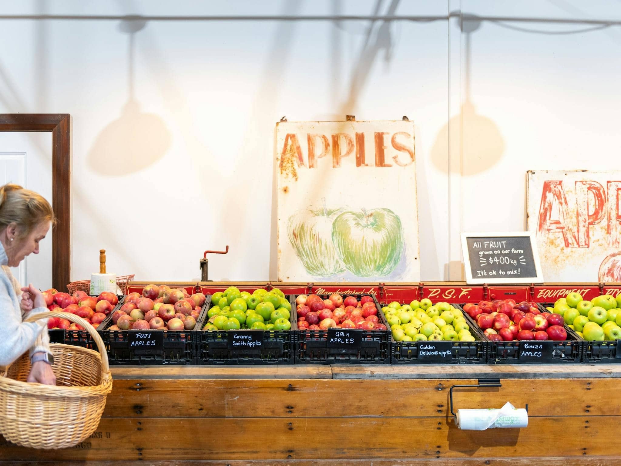 Hillside Harvest farm store apple display with fuji granny smith gala and golden delicious varieties in crates Orange NSW