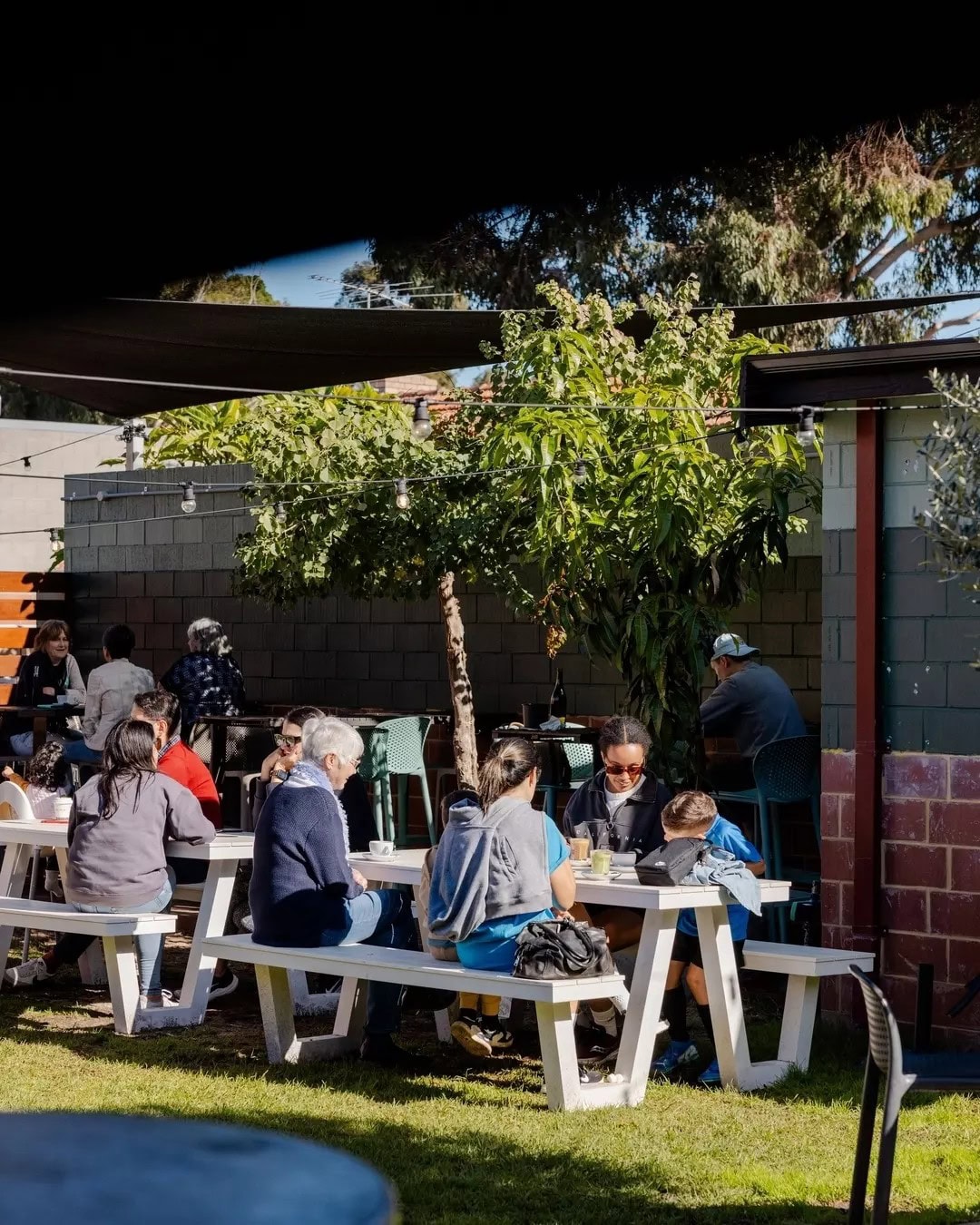 Family sitting outside at Laika cafe