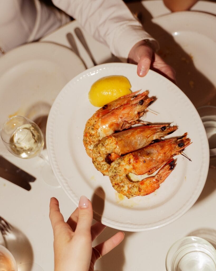 Three large prawns on a platter at Hellenika in Brisbane.