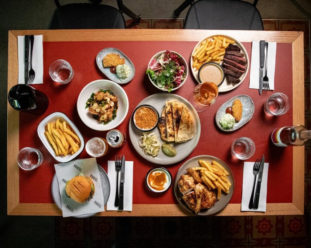 aerial shot of midweek dining deal spread from terra canberra including steak frites, chicken and a wagyu cheeseburger