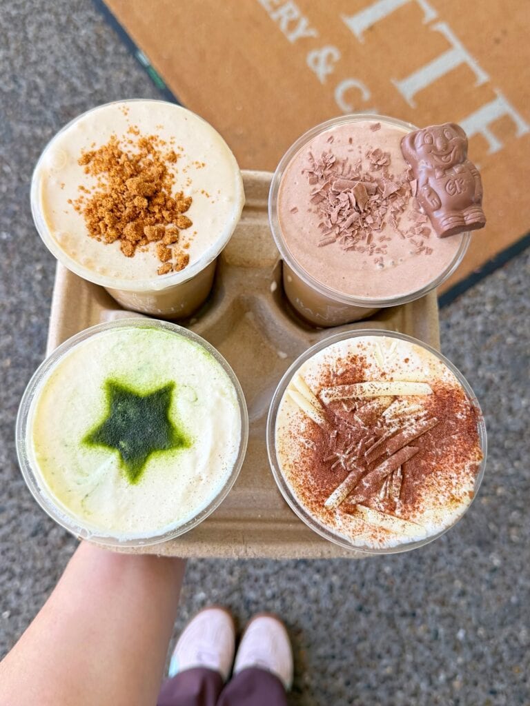 A tray of four decorated iced lattes from Banette Bayside in Brisbane. 