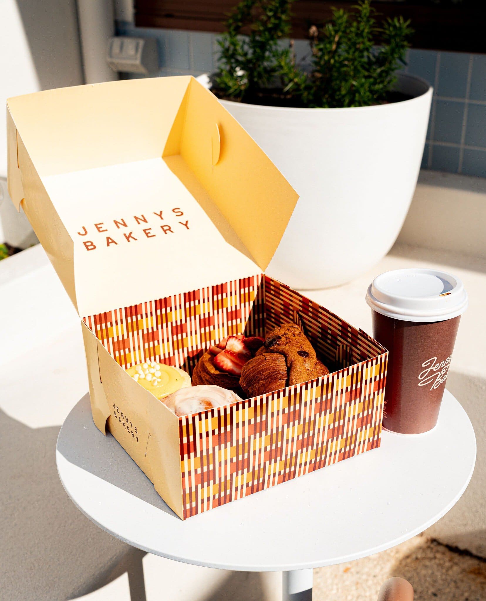 Takeaway box of pastries from Jenny's Bakery in Adelaide.
