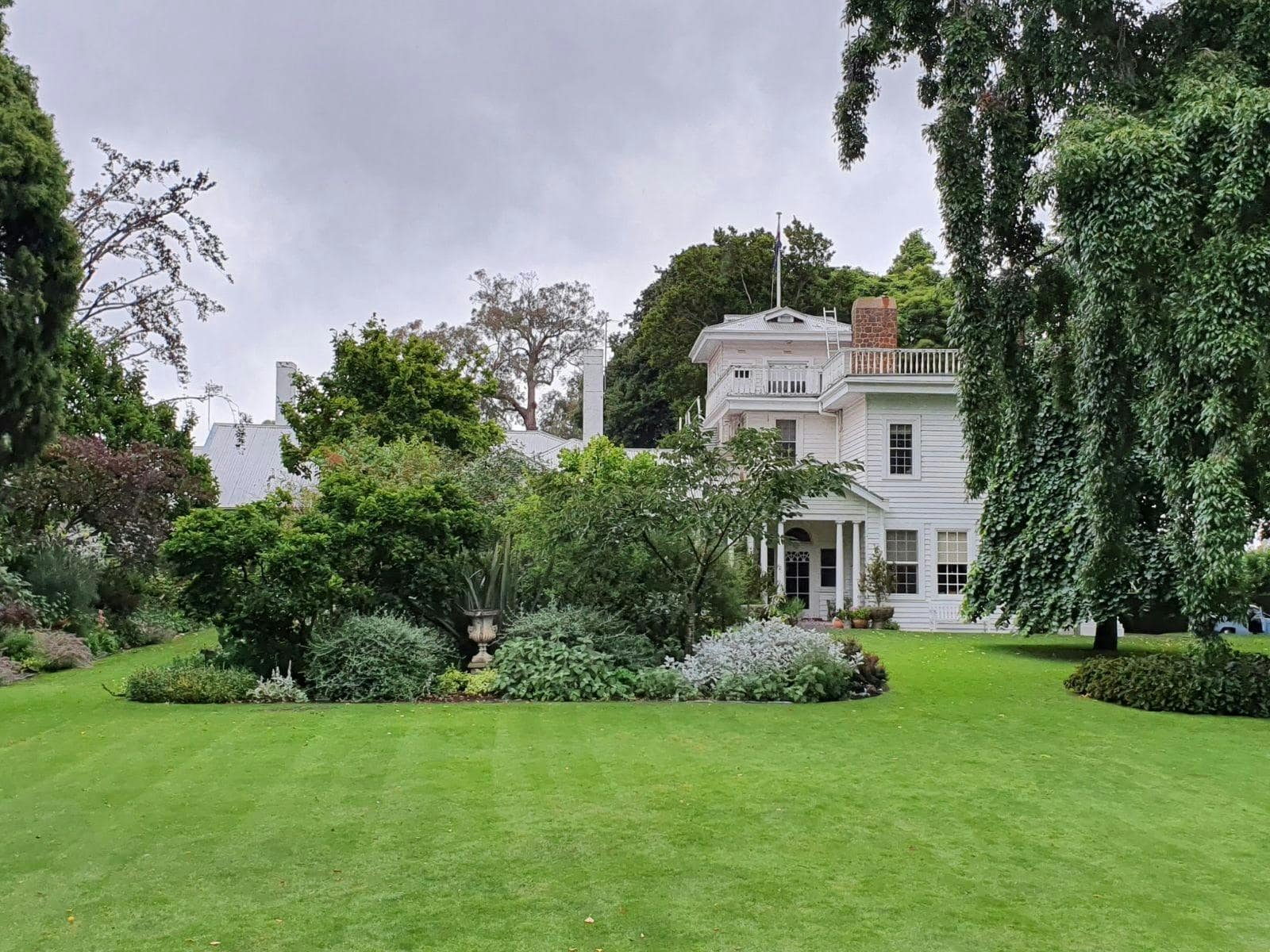 Cruden Farm’s historic white homestead surrounded by lawns and established gardens in Langwarrin.
