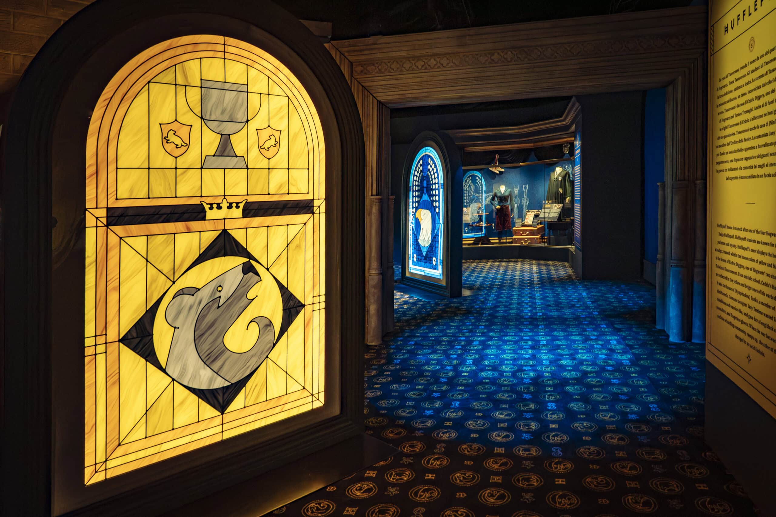 Hogwarts Houses Gallery with Hufflepuff stained glass window display at Harry Potter The Exhibition Sydney Olympic Park