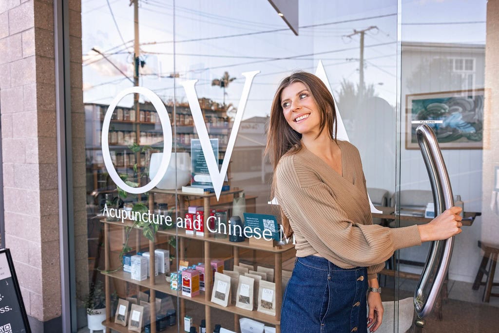 woman walking into Ova Acupuncture clinic