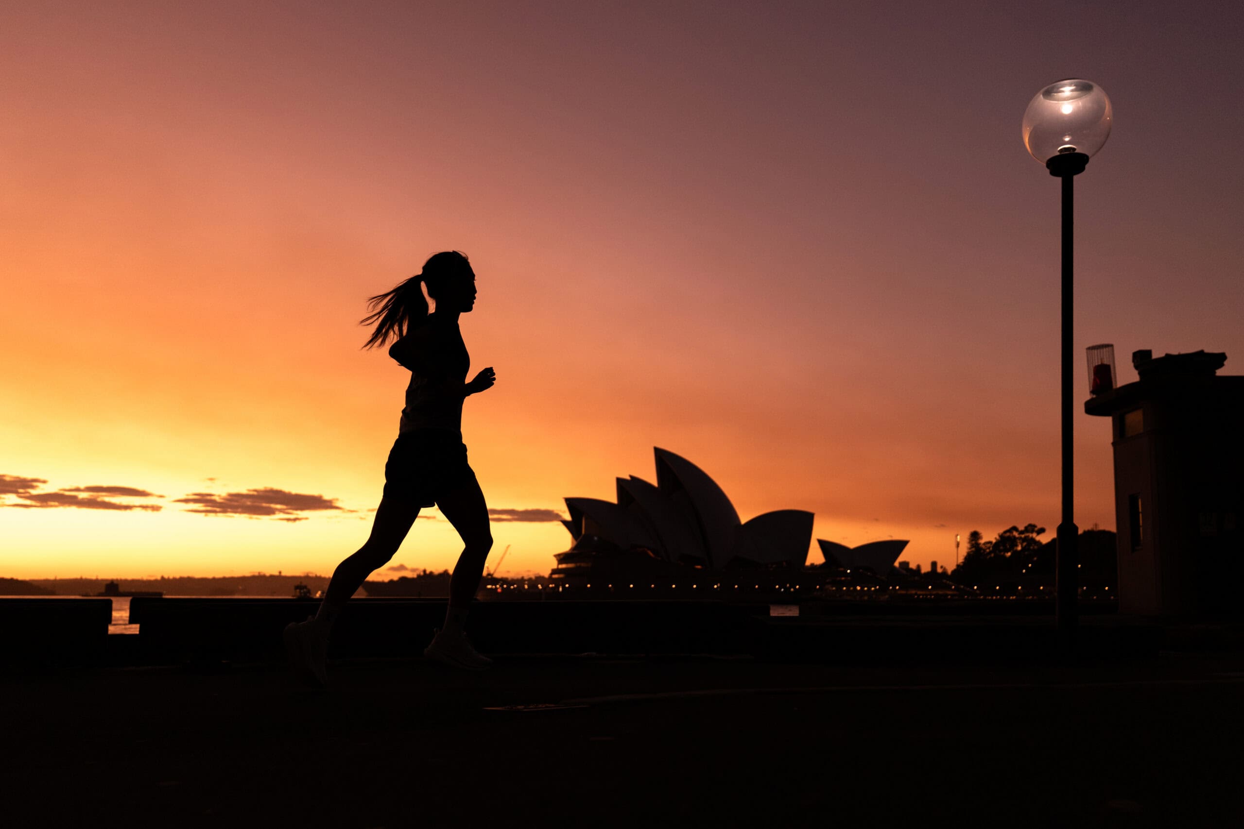 Runner silhouette at sunrise with Sydney Opera House in background at Real Insurance Harbour 10 Barangaroo Sydney