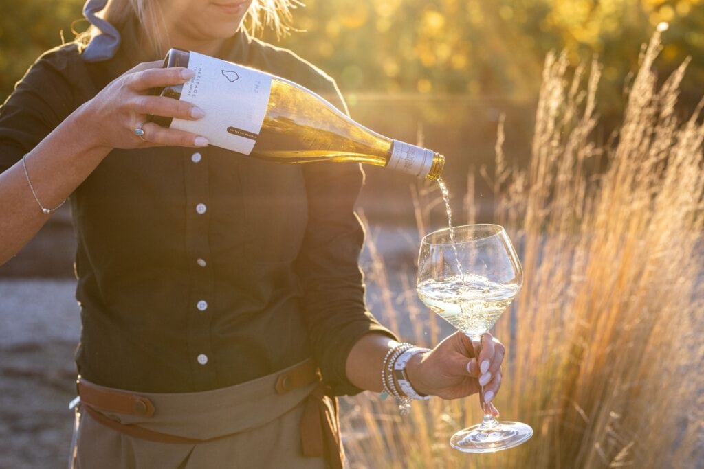 Pouring white wine at The Lane Vineyard in South Australia.
