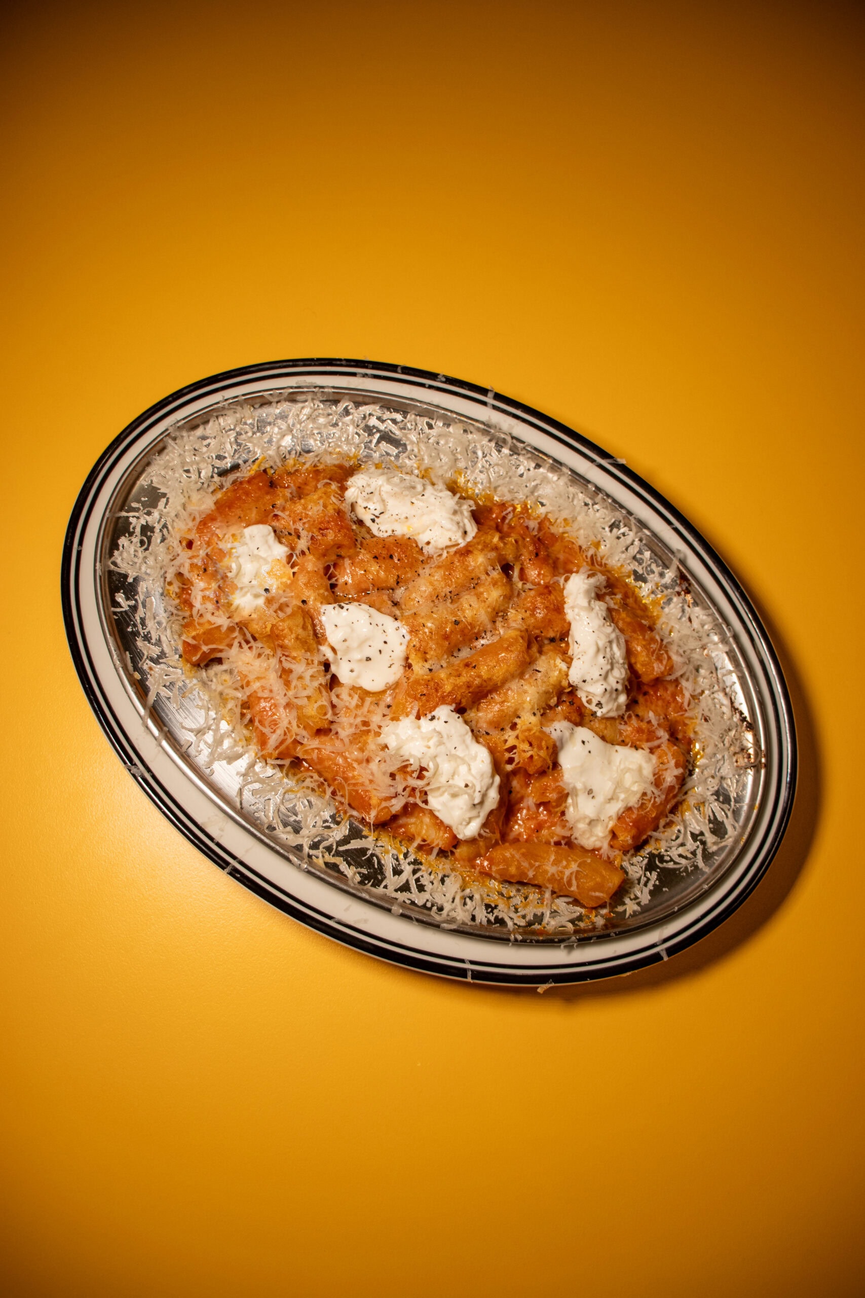 a pasta dish covered in cheese at sugo