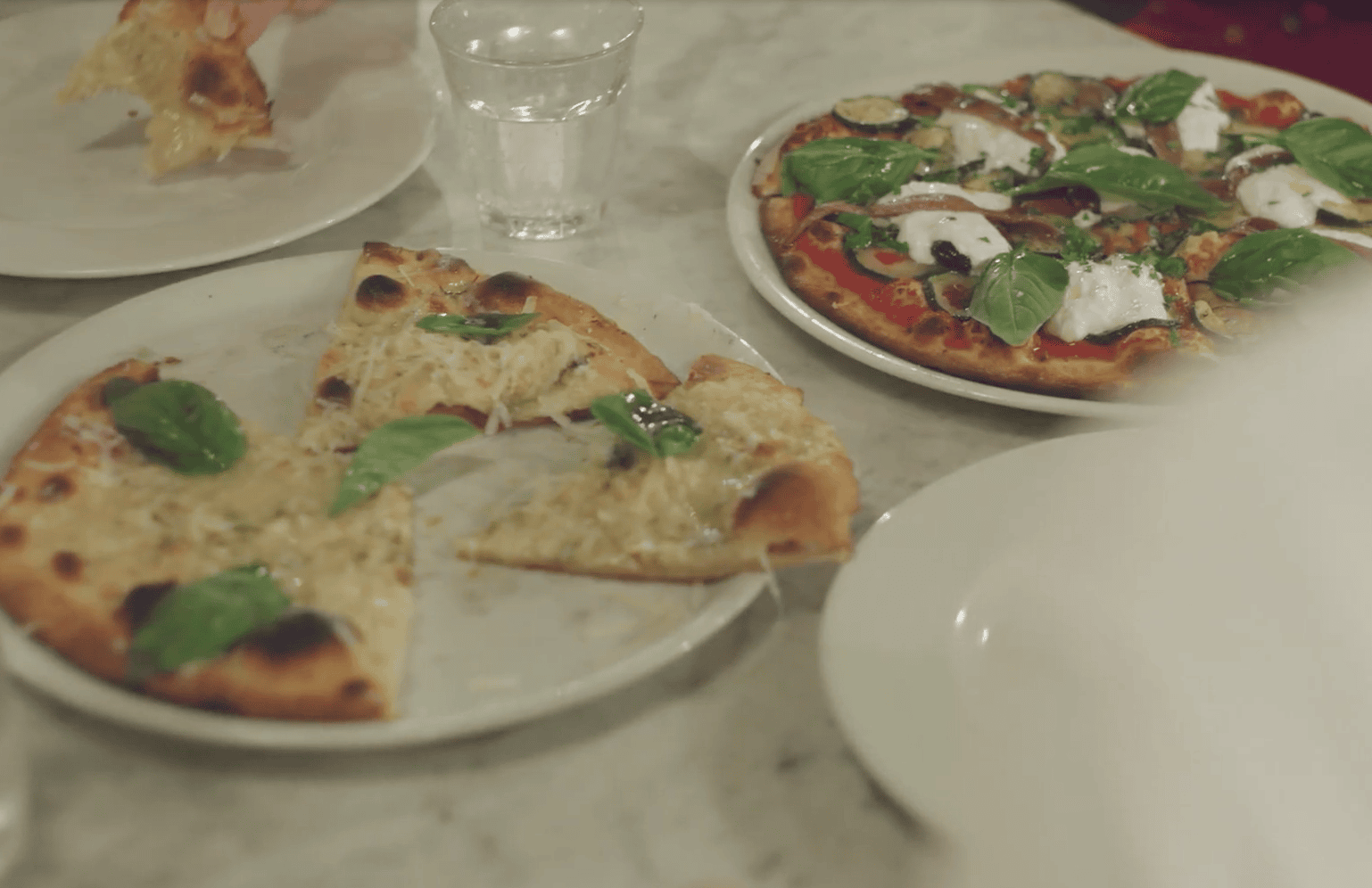 Freshly baked pizza with basil and cheese at a top Paddington eatery.
