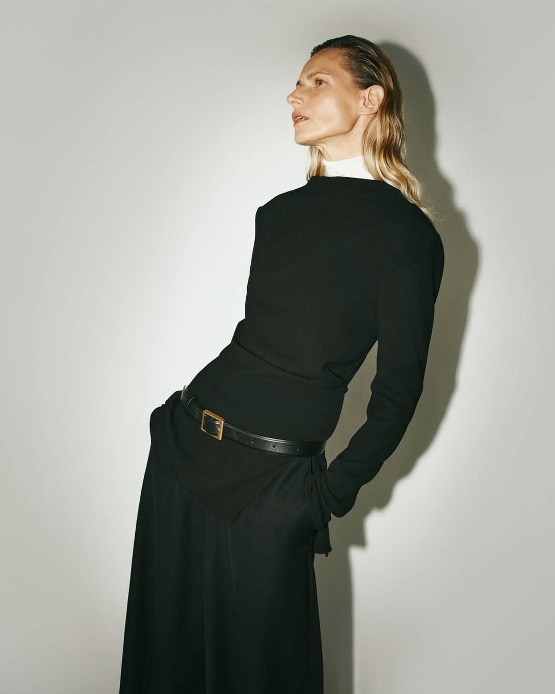 christopher esber model wearing a long sleeve black top with a black belt and black trousers