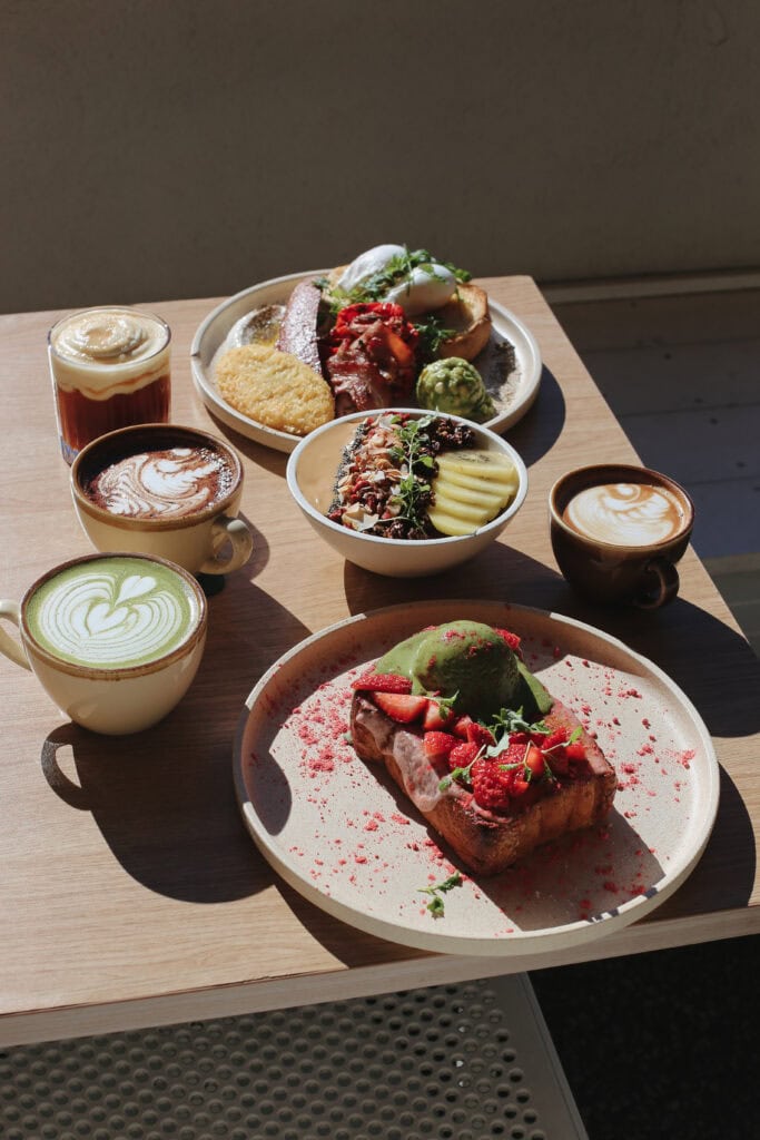 yolk cafe spread of brunch items, matcha and coffee