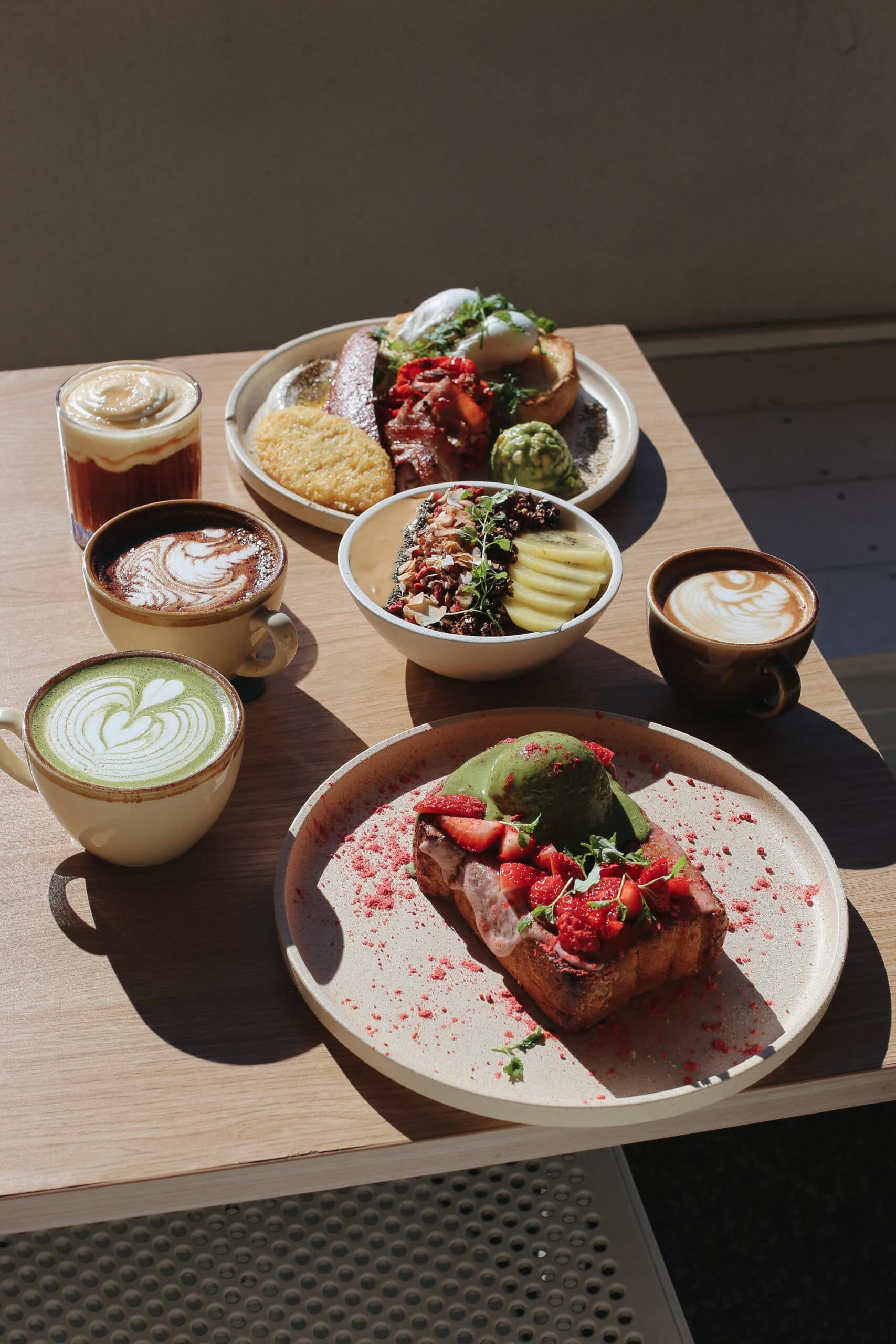 yolk cafe spread of brunch items, matcha and coffee