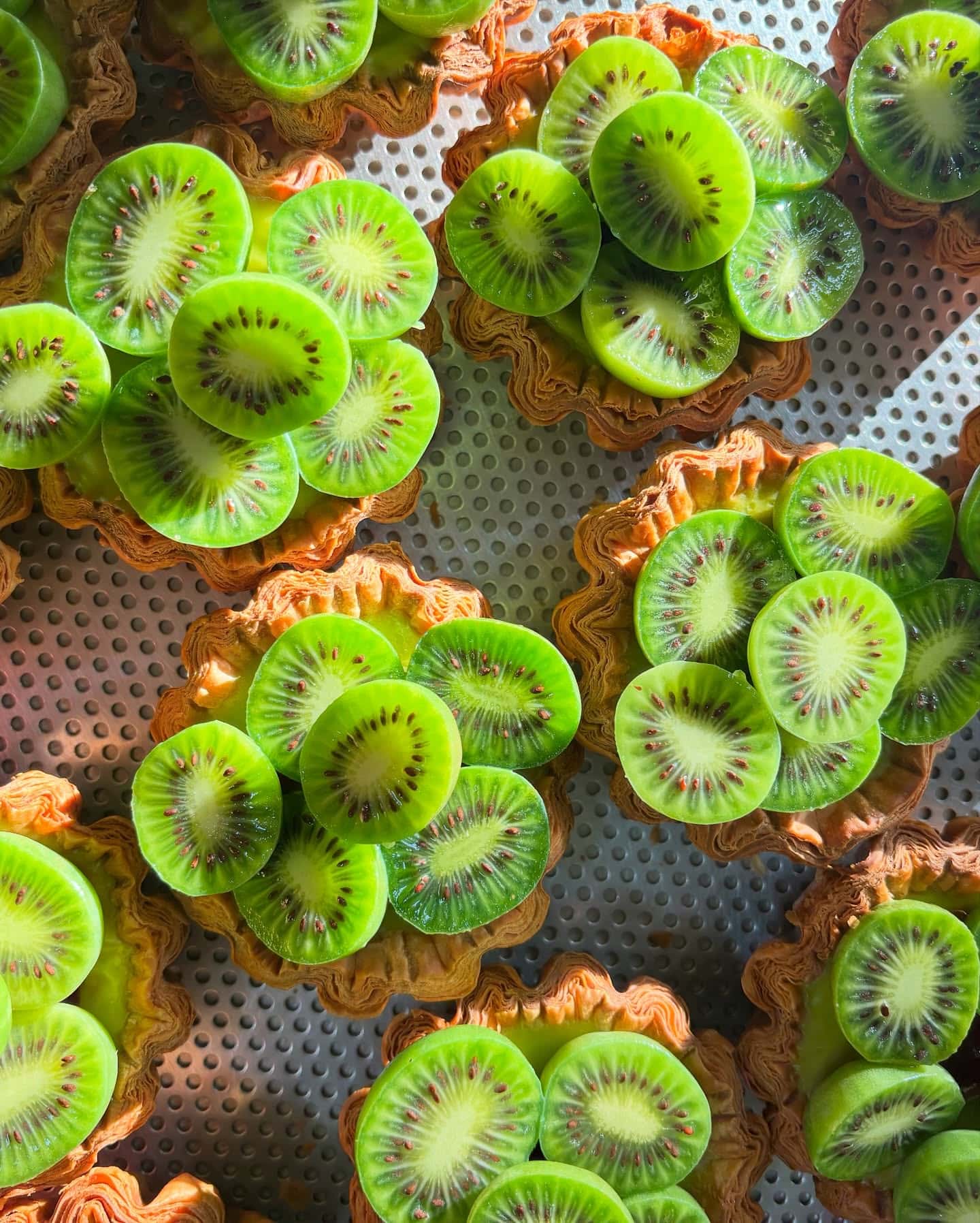 Kiwi fruit tarts with crisp laminated pastry at Amann Patisserie in Carlton North, Melbourne.