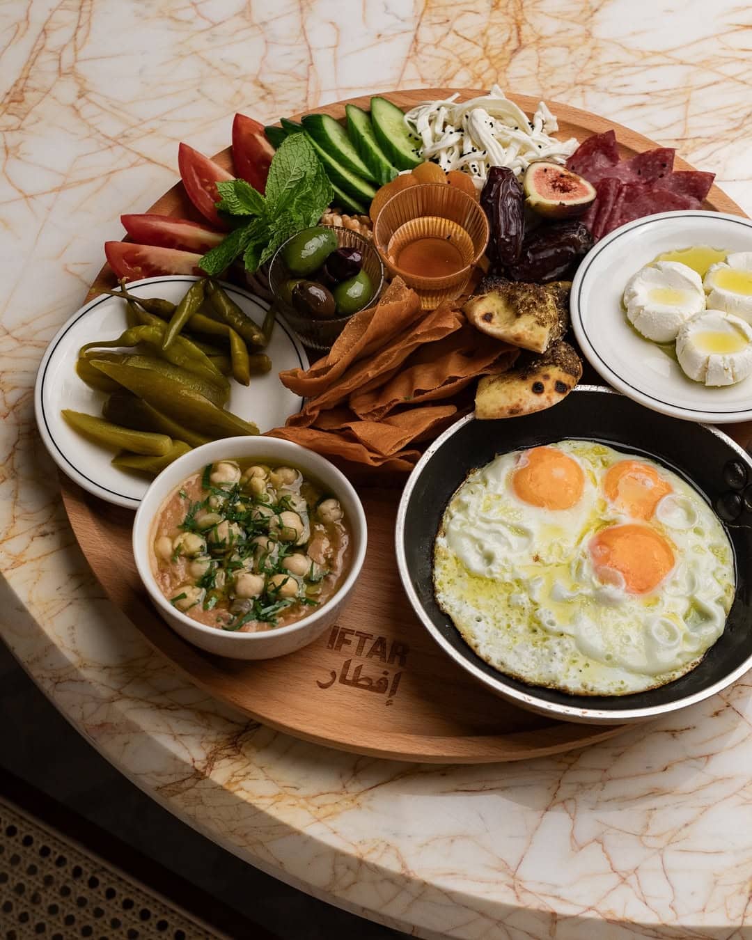 A huge breakfast platter packed with various Middle Eastern accoutrements and eggs at Iftar in Merrylands.