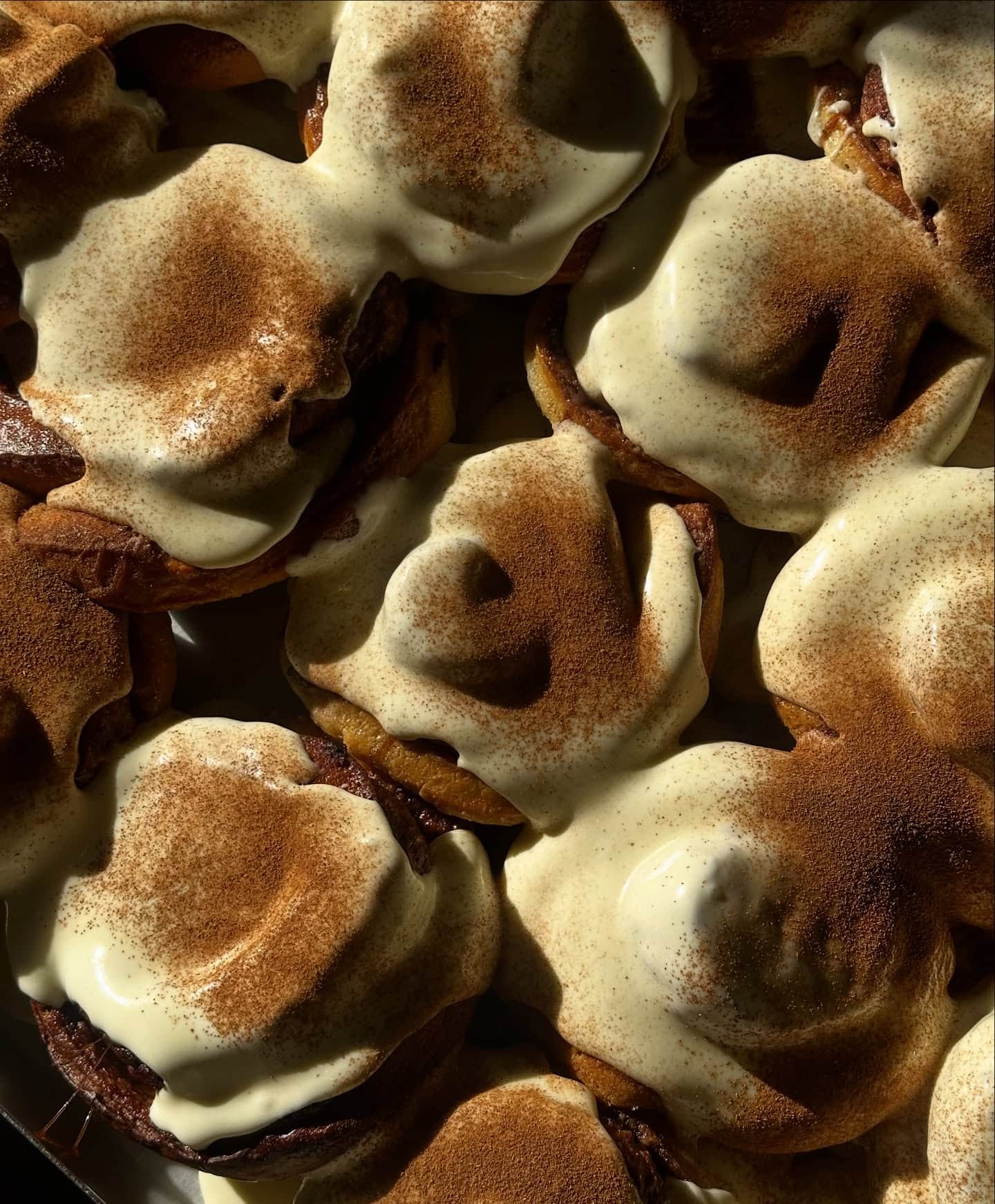 Cream cheese-glazed cinnamon scrolls dusted with cinnamon at Calle Bakery in Northcote, Melbourne.