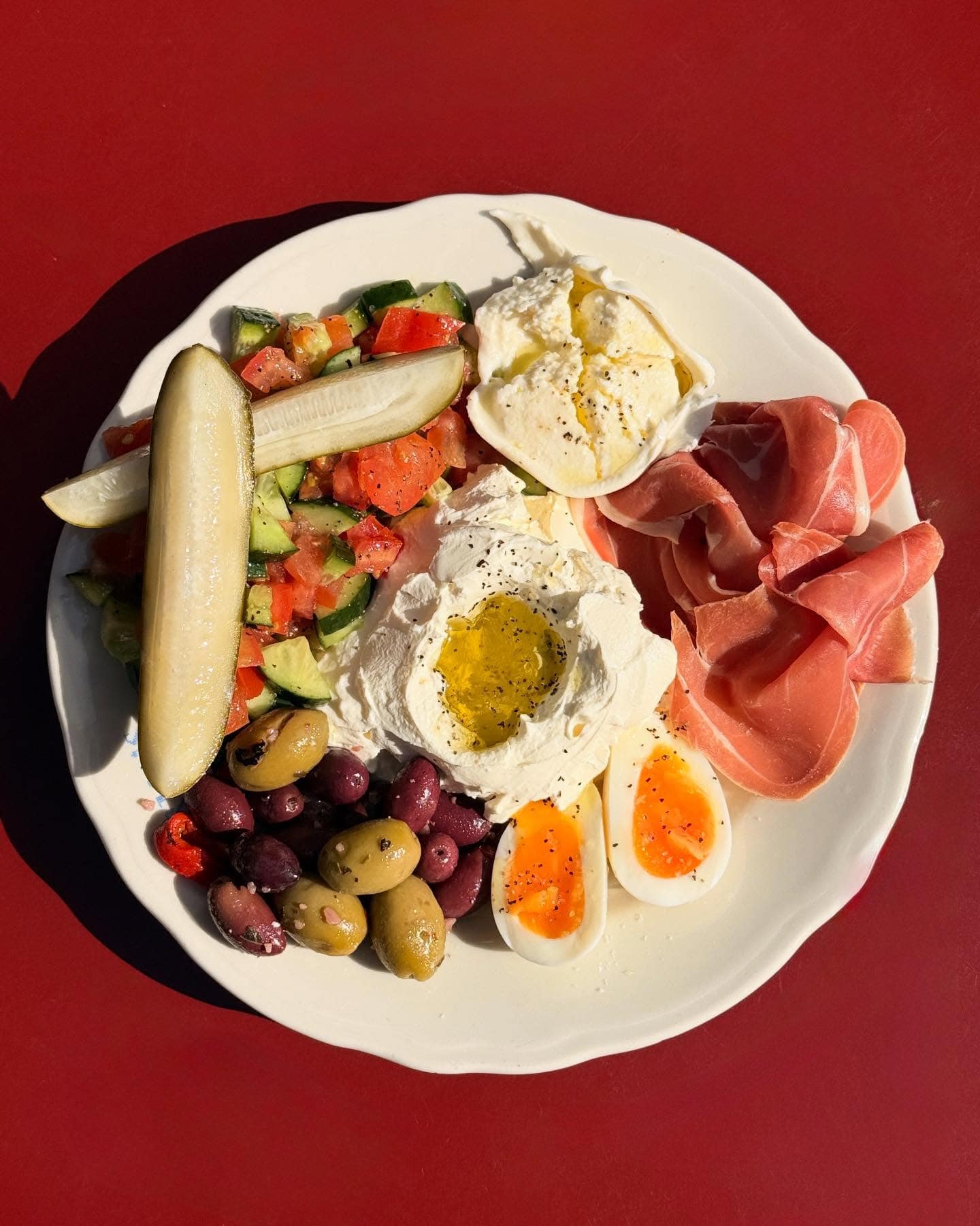 A deli plate of labneh, eggs, olives and more from Norma's Deli in Manly.