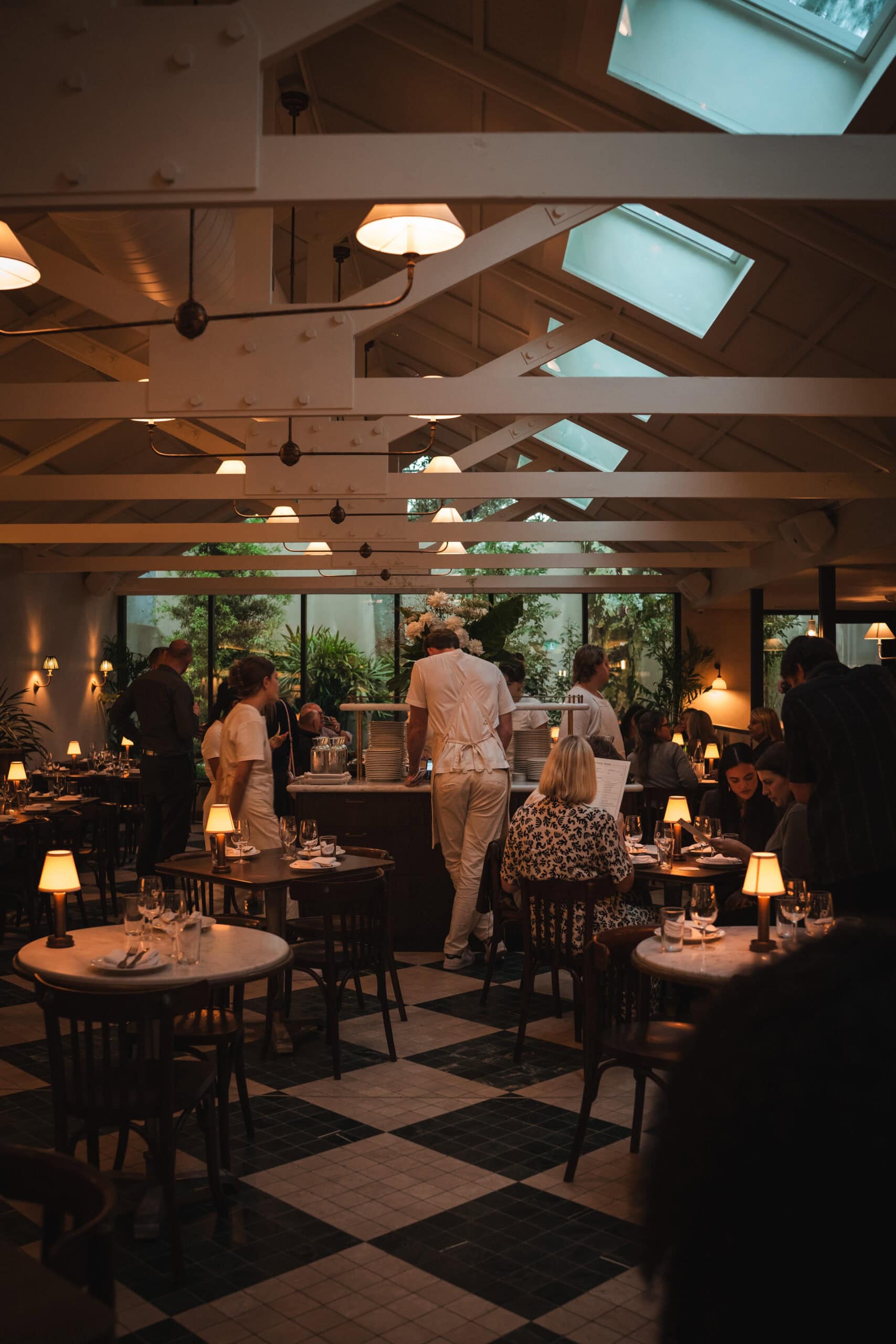 Dining room with staff at service and checkered tile floors at The Dry Dock Balmain Sydney