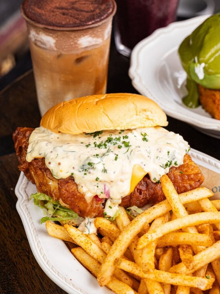 Double barramundi fish burger with melted American cheese salmon egg tartare and seasoned fries at End Of King Newtown Sydney