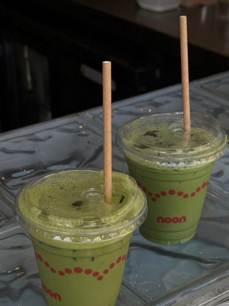 Two iced matcha lattes in branded Noon cups Manly Sydney